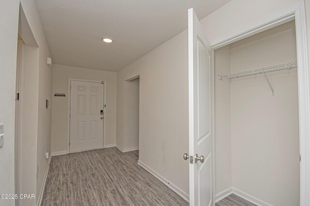 hallway with light hardwood / wood-style floors