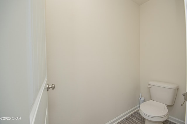 bathroom featuring hardwood / wood-style floors and toilet