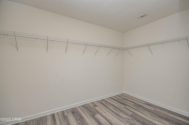 spacious closet featuring hardwood / wood-style floors