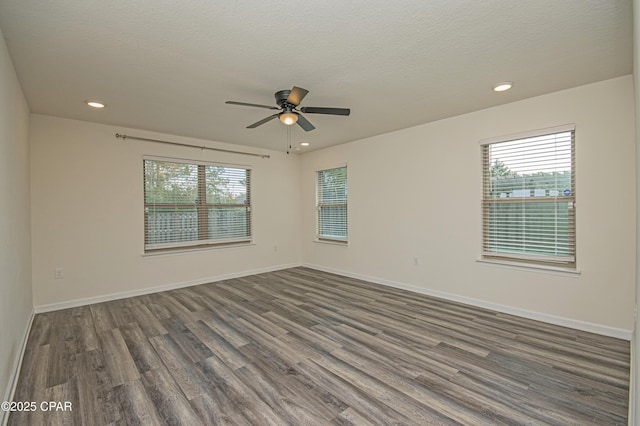 unfurnished room featuring ceiling fan, a textured ceiling, wood-type flooring, and a healthy amount of sunlight