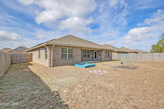 back of property featuring a playground