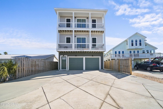 view of front facade featuring a garage and a balcony