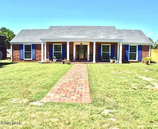 single story home featuring a front yard and covered porch