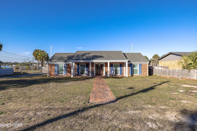 view of front of house featuring covered porch and a front lawn