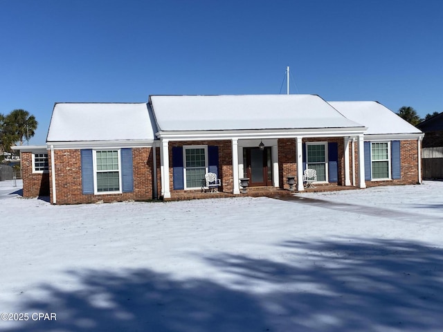 view of front of home featuring a porch and brick siding