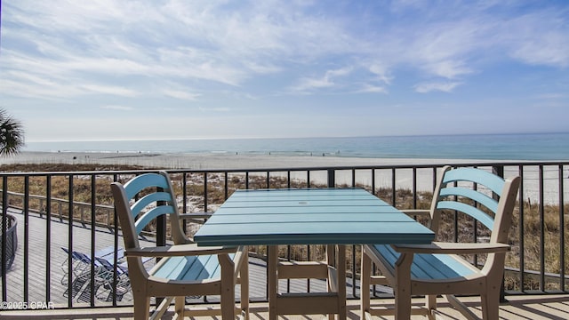 balcony featuring a water view and a beach view