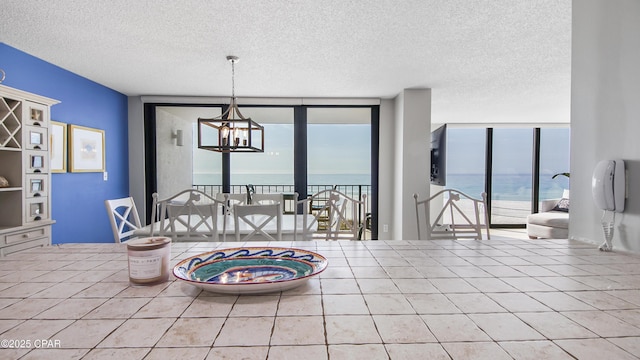 dining area featuring a wealth of natural light, floor to ceiling windows, and a chandelier