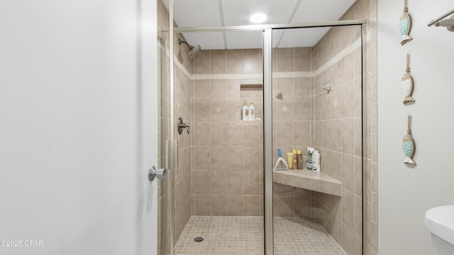 bathroom with a shower with door and toilet