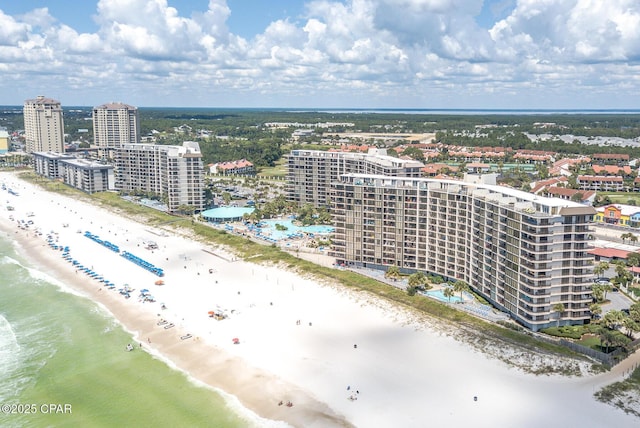 drone / aerial view featuring a water view and a beach view