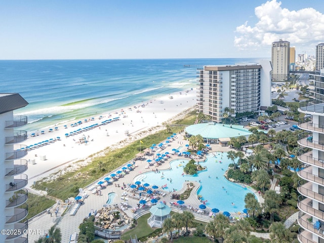 birds eye view of property with a water view and a beach view