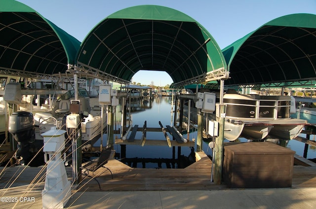 dock area with a water view and boat lift