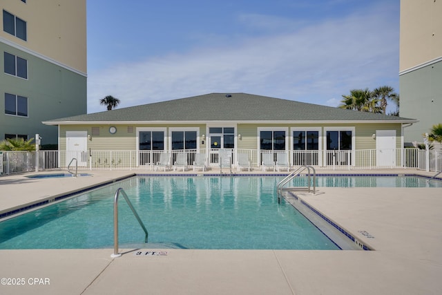 community pool featuring fence and a patio