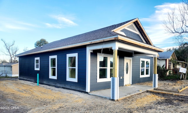 view of property exterior with a shingled roof