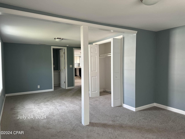 unfurnished bedroom with a closet and carpet flooring