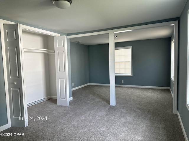 unfurnished bedroom with carpet floors and a closet