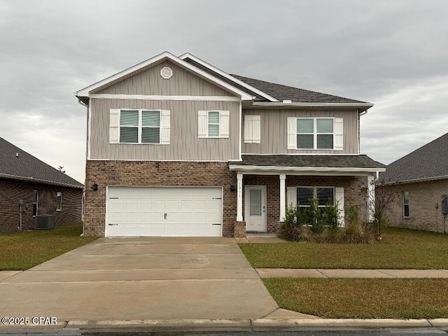 view of front of property featuring a front lawn, concrete driveway, brick siding, and an attached garage