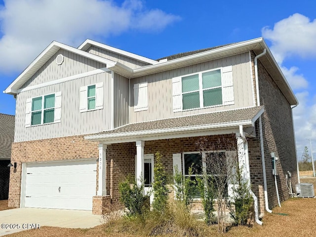 view of front of house with an attached garage, brick siding, cooling unit, and driveway
