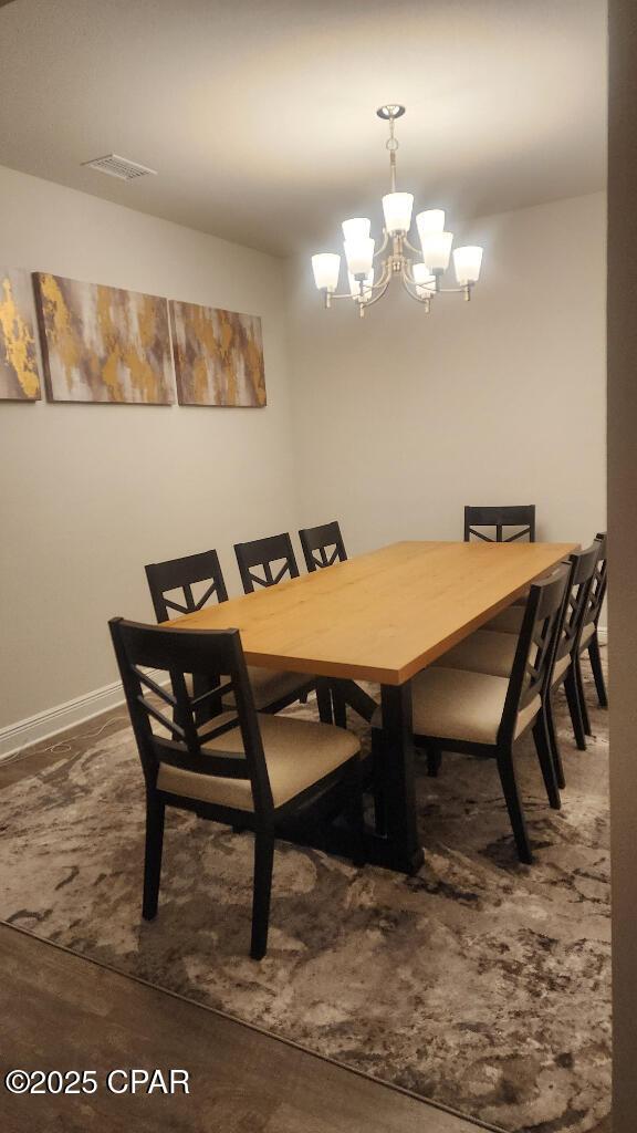 dining space featuring a notable chandelier