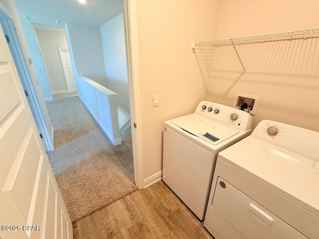 washroom with washer and clothes dryer, baseboards, and light carpet