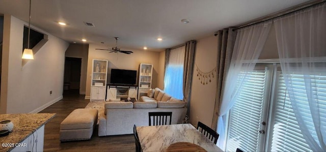 living room featuring dark hardwood / wood-style floors and ceiling fan