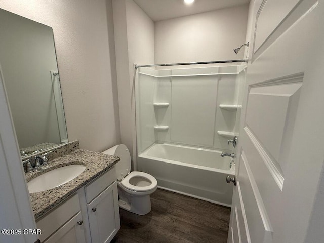 full bath with toilet, shower / tub combination, wood finished floors, and vanity