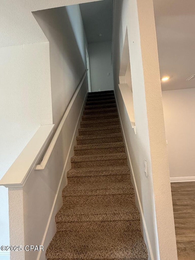 stairway featuring baseboards