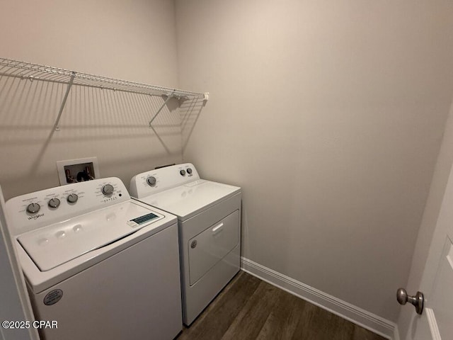 washroom with laundry area, washing machine and dryer, dark wood-style floors, and baseboards