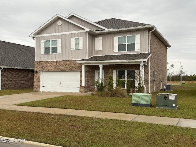 view of front of home featuring cooling unit, a garage, and a front yard