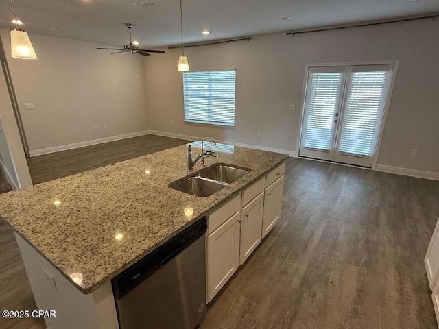 kitchen featuring sink, white cabinetry, decorative light fixtures, dishwasher, and a kitchen island with sink