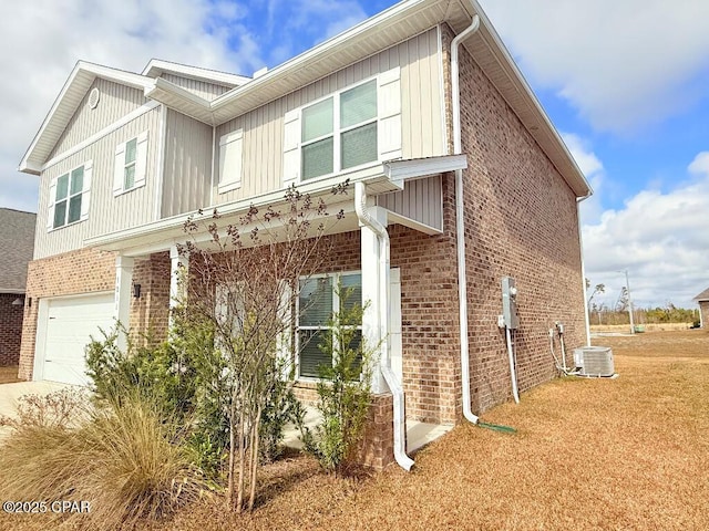 view of property exterior featuring central AC unit, an attached garage, brick siding, and concrete driveway