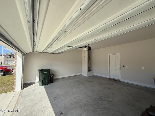 garage with a garage door opener, water heater, and baseboards