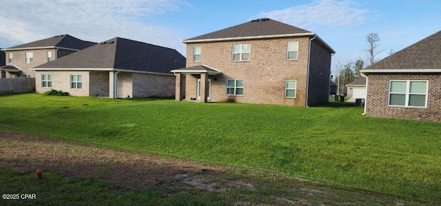 back of property featuring brick siding and a lawn