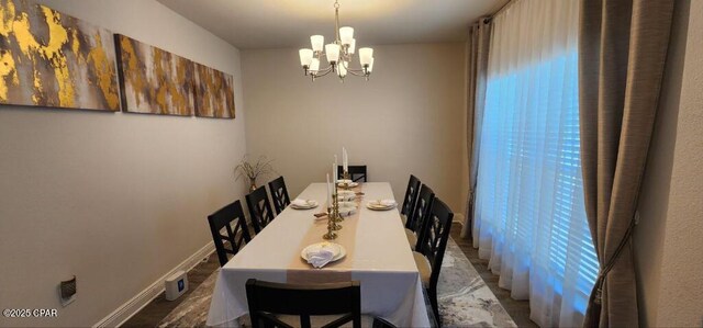 dining space featuring a notable chandelier