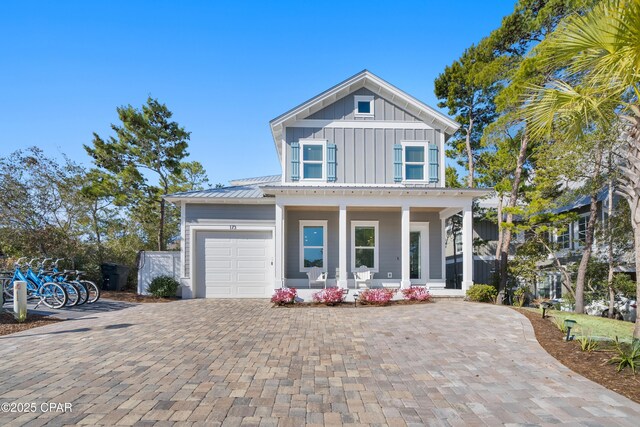 view of front of property with a porch and a garage