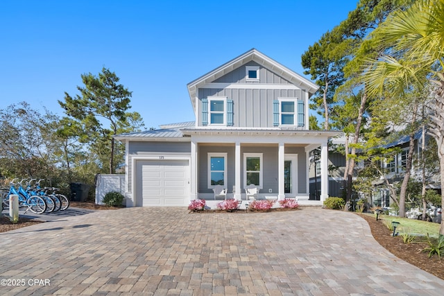 173 W Willow Mist Rd, Inlet Beach, FL 32461 - view of front of property with board and batten siding, a porch, decorative driveway, a garage, and metal roof