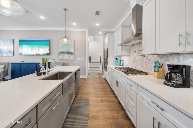 173 W Willow Mist Rd, Inlet Beach, FL 32461 - kitchen featuring wall chimney exhaust hood, stainless steel appliances, wood finished floors, a sink, and backsplash