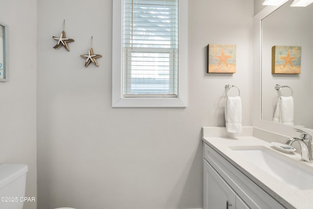 bathroom featuring toilet and vanity