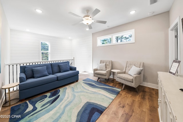 living room featuring dark wood-type flooring, recessed lighting, plenty of natural light, and baseboards