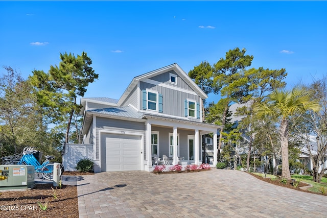 173 W Willow Mist Rd, Inlet Beach, FL 32461 - view of front of property featuring a porch, board and batten siding, a garage, decorative driveway, and metal roof