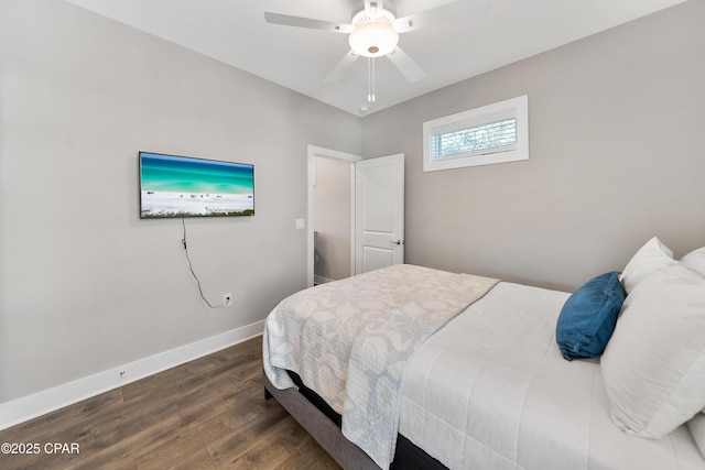 bedroom with dark wood-style floors, ceiling fan, and baseboards