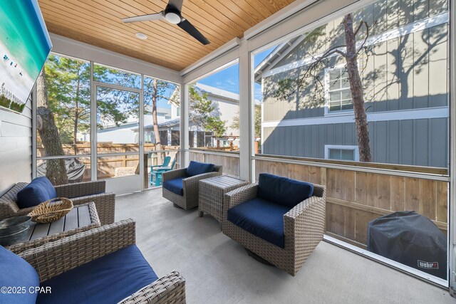 sunroom / solarium with wood ceiling and ceiling fan