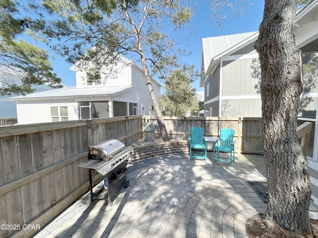 wooden terrace featuring a patio, grilling area, and fence