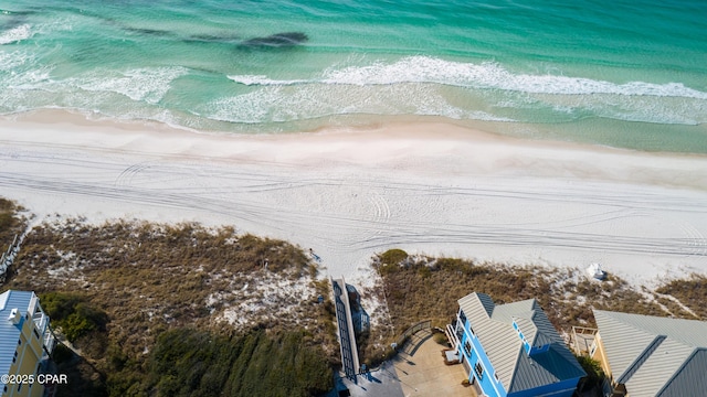 drone / aerial view featuring a water view and a view of the beach