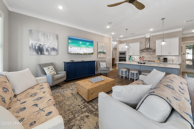 living area with recessed lighting, dark wood-type flooring, visible vents, a ceiling fan, and ornamental molding