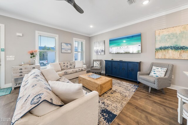 living room with baseboards, visible vents, ornamental molding, dark wood-type flooring, and recessed lighting