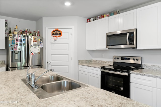 kitchen featuring white cabinetry, appliances with stainless steel finishes, and sink