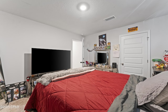 carpeted bedroom with a textured ceiling