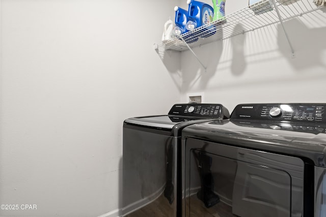 laundry area with wood-type flooring and washing machine and dryer