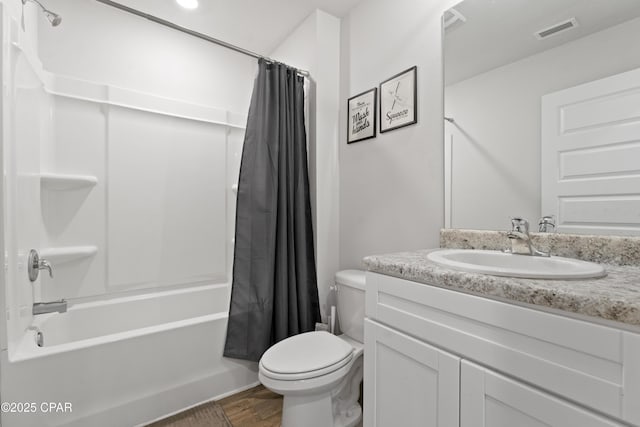 full bathroom featuring vanity, wood-type flooring, shower / bath combo, and toilet