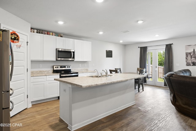 kitchen featuring sink, a kitchen island with sink, stainless steel appliances, white cabinets, and french doors